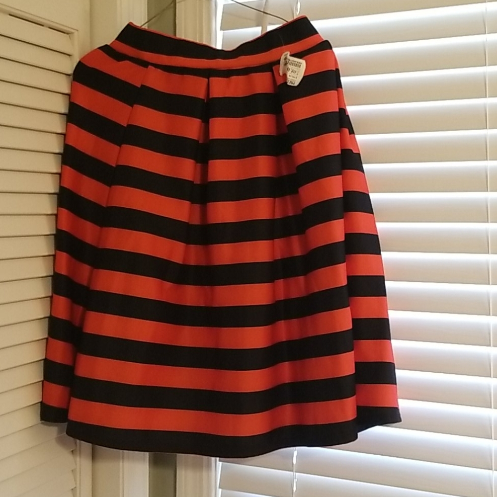 Medium. Red and black pleated skirt.